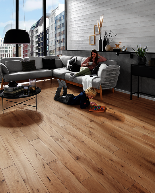 Mother and son in a bright living room with Osmo profiled wood and solid wood Oak flooring