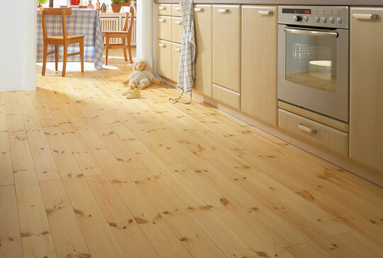 Osmo wooden flooring made from solid Pine provides warmth in the kitchen.