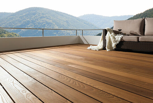 Osmo Thermo Wood Ash decking on a balcony with a view