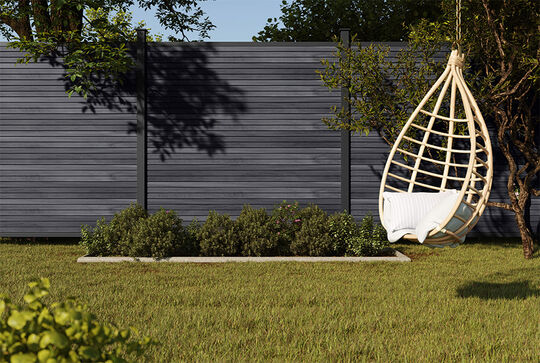 Hanging garden chair in front of the BPC privacy screen Multi-Fence Cube in Stonegrey from Osmo