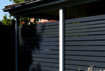 Privacy screen Osmo Alu-Fence Rhombus in anthracite grey hides views onto the carport.