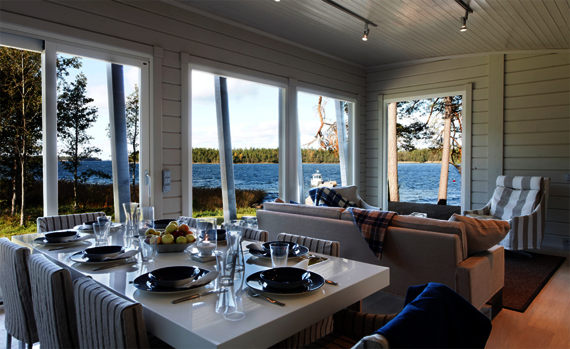 Light-coloured wall panelling and wooden flooring in a weekend get-away house finished with Osmo