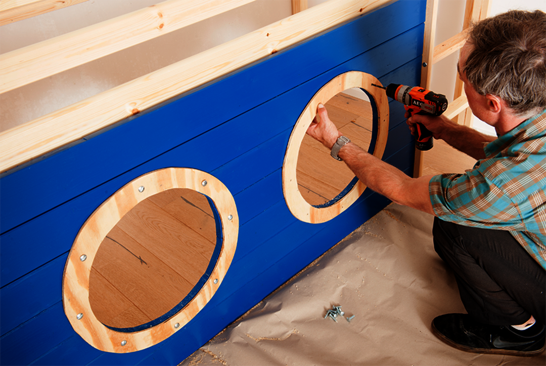 Osmo Schiff Hochbett Bauanleitung - acht Löcher in die Bullaugen bohren und die Linsenkopfschrauben in die Löcher kleben