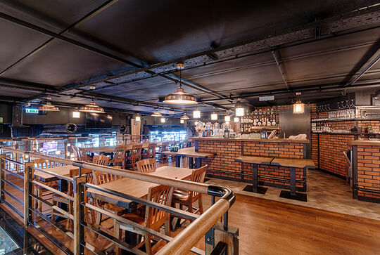 Erster Stock der Brauerei Trzy Koronoy – Tische, Geländer, Arbeitsplatten der Theke und Stühle aus Holz gepflegt mit Osmo - Referenz 