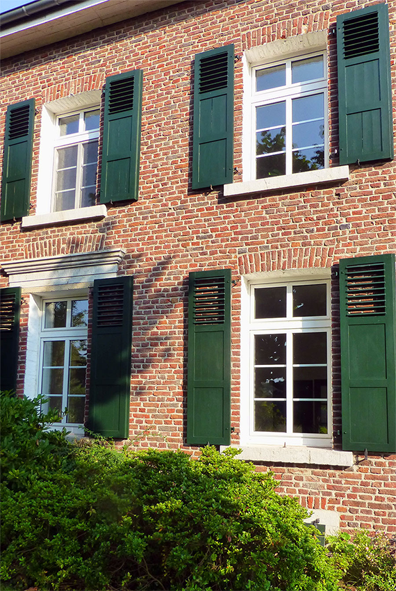 Colourful window shutters for a decorative house